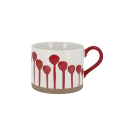 Tasse blanche à tâches rouges
